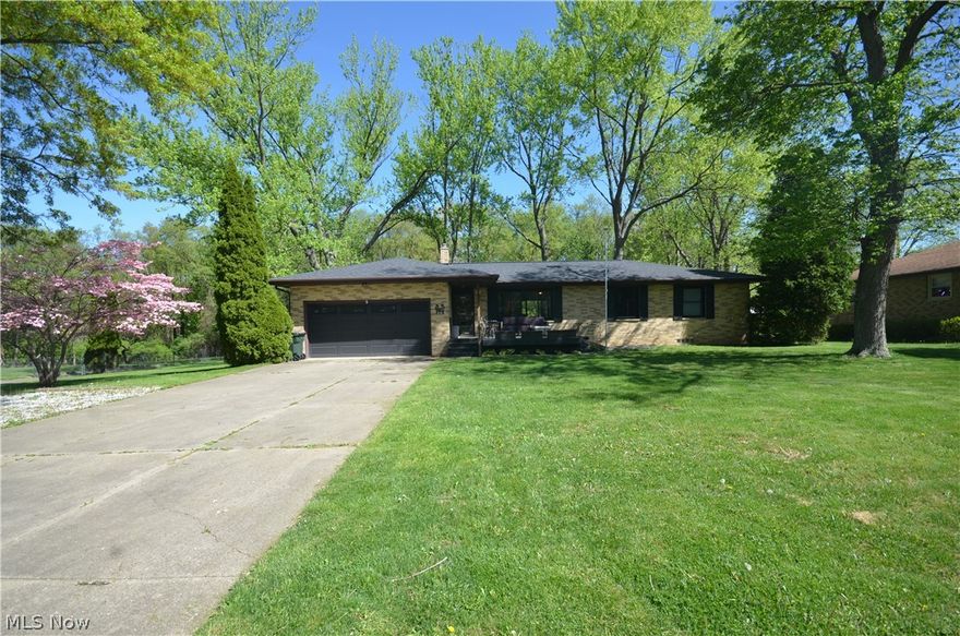 All Brick Tallmadge Ranch on one of the most picture perfect & private lots around w shed! Gorgeous wooded views w deer & wildlife from your deck or enclosed sun rm. This quality-built home has tons of big ticket items updated too! 2225 Finished Sq Ft w the finished basement! Spacious front room w picture window flows to the kitchen w custom cabinets & tile flooring. Great open layout to the coffee bar area w lg window overlooking the back yard. Family rm was completely remodeled w new drywall, flooring, paint & a closet for great storage off of the garage. Beautiful new slider leads to the new Sunroom enclosing the Naturestone patio w skylights & electric. Storage is everywhere- large closet by kit, cleaning/linen closet in the hall. Full bth w large custom vanity, shower/tub w tile surround & laundry chute. The bedrooms offer great closet space- all w lights & 2 w closet organizers. Mst bedroom  offers a private & giant ½ bth w big vanity. Hardwood floors in front rm, hall & bedrooms! Expansive finished basement complete w custom rounded wet bar, built in storage/shelving, more closet space, plus a full bathroom & office/potential bd #4 directly across from the bath. Updates include ‘22 Microwave. ‘21 Windows, Sunroom Enclosure, Chimney repairs, Misc Masonry work, water line to coffee bar. ‘19 Dimensional Shingle Roof w Ridge Vent, Vent Kit & Bth Fans, Shutters, Front & Back Deck, Driveway Turnaround/parking w block border, Plank Vinyl flooring. ‘17 Electrical Panel, Service Line & Sub-Panel. ‘16 Family Room Remodel, Family Rm Windows & Slider.  ’14 HW tank. ’11 AC & Furnace w AprilAire Humidifier, ’10 Blown Insulation, Light Fixtures (Kit, Dining, Bedrooms) & Moen Faucets (Kit & Bth). 2 car garage w overhead door w windows, gutter guards & concrete drive. Mature trees, firepit added out back  & easy access to many amenities in the city. Custom ceilings throughout & many fine details in this high quality home. Kitchen/dining will need some drywall/tile/trim work.