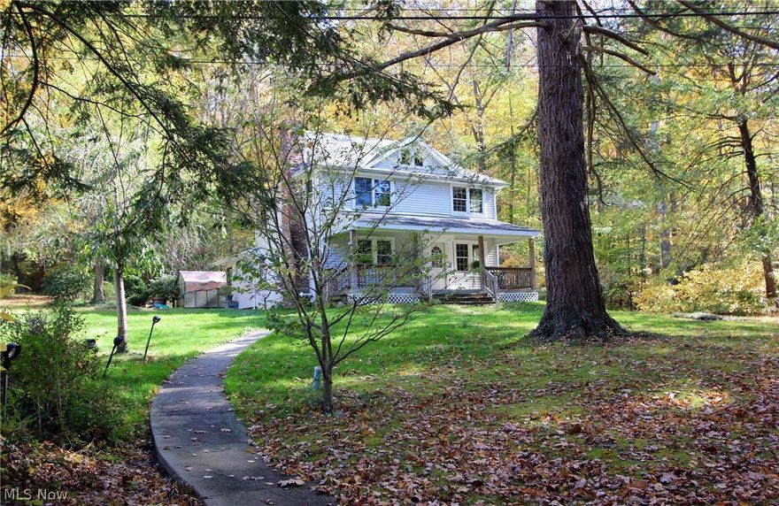 Magnificent landmark property with over 700 feet of frontage along the Chagrin River, accessible by footbridge only. There are 2 homes on the property which is located adjacent to 10 acres owned by the Gates Mills Land Conservancy.  The 3 bedroom main house, situated next to a winding creek features hardwood floors, wormy chestnut millwork, and a river-stone fireplace with stones handpicked from the Chagrin River. The guest house is a one bedroom cottage designed by noted architect, George Brown, and has been used as an income producing rental property. The ultimate in privacy and seclusion, the property is a nature lover's dream.  Currently, it is only accessible by the footbridge but the new owner could build a drive along an existing easement accessed off County Line Rd.
