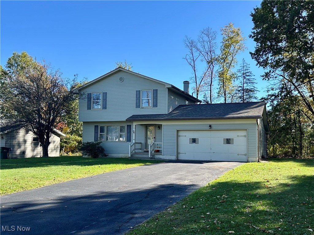 WELCOME to your next home!! This home sits back off the road with a attached garage and covered front porch leading into a entry with stairs, a open concept Living Room with lots of natural sunlight, Dining Room and spacious kitchen with windows looking out on the tree lined back yard. Upstairs you have 3 comfortable Bedrooms with ample closets and a full Bath. All 1st & 2nd Floor Rooms have hardwood floors under the carpeting. In the Basement is a finished Rec Room which adds to even more living space & a Laundry Room with Lots of storage & folding space. Enjoy outdoor living on the screened porch overlooking the back yard.  Perfect for relaxing or entertaining. Located in Austintown School district with a Canfield Mailing address & in close proximity to shopping, restaurants, banking, etc. This Quality built home is the perfect setting for Family Memories inside & out. Roof is 2 Years old, Siding New in 2017, Furnace & Central Air new in 2019 & brand new Dishwasher & Roof. A little TLC with Cosmetics will make this the home of your dreams!!