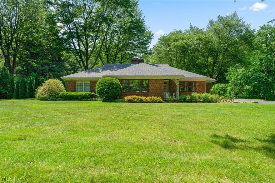 This amazingly updated & meticulously cared for 2204 sq ft, BRICK RANCH, in Canfield School District, on SIX+ ACRES (partially wooded), with an enormous outbuilding (2012), has it all! Mineral Rights included! New roof (2019). Furnace & central air (2012). Huge rooms. The stunning kitchen was completely updated, in 2010, with gorgeous cabinetry, granite countertops, and ceramic backsplash & flooring. The attractive main (dual-headed shower...ahhh!) and half baths have both been updated (2011 & 2018, respectively). The formal living & dining rooms and the primary & secondary bedrooms all boast original hardwood flooring! The formal living room is capped off with a lovely, wood-burning fireplace. The family room (gas) fireplace wall has floor-to-ceiling cabinetry & shelving. Off the family room, is an enclosed patio which leads out to a paver patio and a quaint pergola! The covered, cement porch steps down to another pretty paver patio. The outbuilding (holds approximately 6 average size
