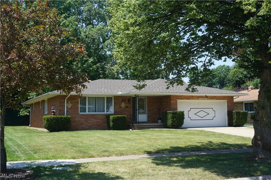 Enjoy first floor living in Seven Hills!  This 4 Bed/2 Full Bath Brick Ranch style home has been very well maintained. You'll fall in love with the large rooms that flow seamlessly together, perfect for entertaining! New Roof & New Backyard Concrete Patio with sidewalk that wraps around the garage all added this year!  Large Eat-in Kitchen that opens to the dining room and Family Room. All appliances included, even washer & dryer! Dining room connects to the large living room with hardwood floors. Bathroom in Family room has a shower. Wood burning Fireplace in Family Room with sliding door to new backyard patio. Hallway and all 4 bedrooms have beautiful hard wood floors. Large hallway bathroom with tub/shower. Enormous basement is half finished with a decorative fireplace and storage benches. The other half has an abundant amount of storage cabinets, Laundry area, and workshop  2 Car attached garage and gorgeous treed backyard that features many raspberry bushes in the far back of the