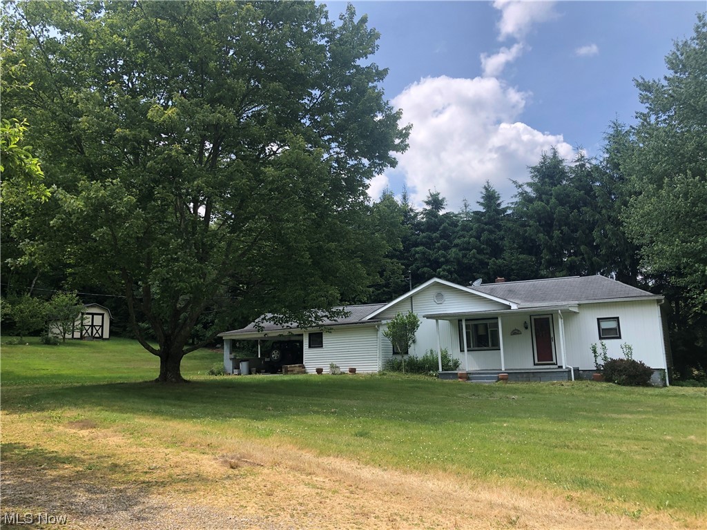 Country Living! 3-4 bedroom ranch on 1 acre. Eat in kitchen includes appliances. Open concept dining room and living room. Split bedroom offers 2 bedrooms on one side with 3rd bedroom and office or possible 4th bedroom & bath on the other side. Full, partially finished basement with laundry room and rec room. New furnace in January of this year. There is an attached carport and shed. This home is ready for your special touch and is located just minutes from Tappan Lake and also close to highway access. Great opportunity to live in the country.