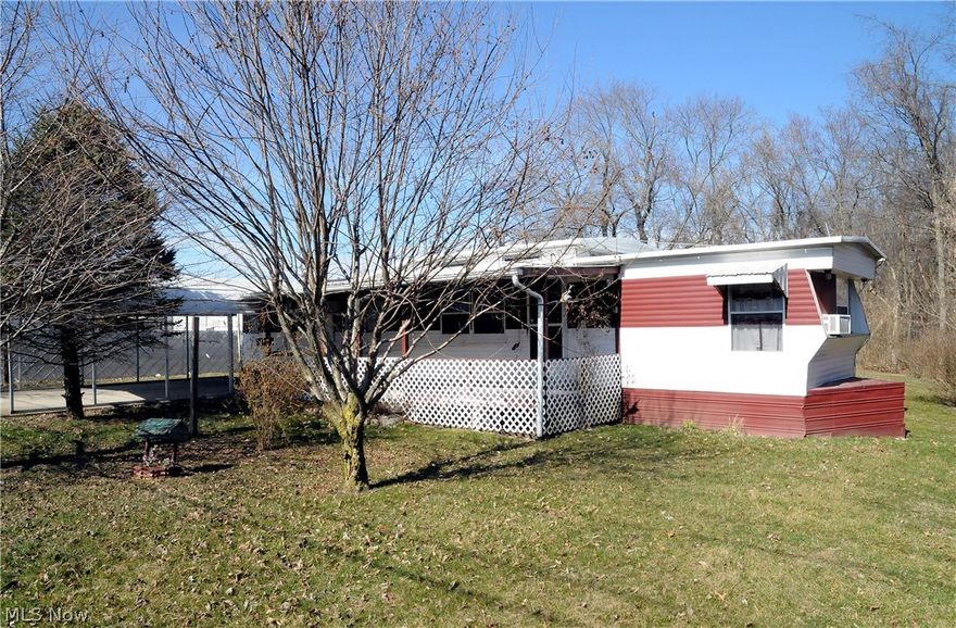 Nice older mobile with many cute built ins.  Level lot, and a handy carport!