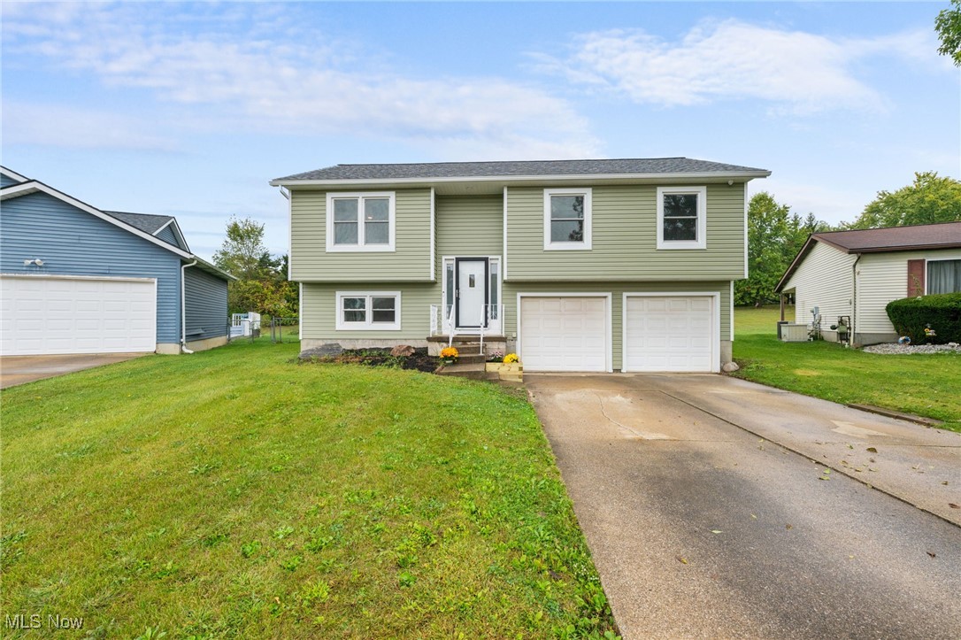 Located on a quiet cul-de-sac, this 4-bed, 1.5-bath home combines comfort with peace of mind. Enjoy the spacious fenced backyard with a newer composite deck (new sliding door 9/25) – perfect for summer barbecues or relaxing evenings. Inside, main living area has fresh paint, new bedroom carpet (9/25), and durable LVT flooring create a warm, move-in ready feel. Major updates include a brand-new roof, gutters, siding (3/25), plus a newer furnace, A/C, and tankless water heater for year-round comfort. The 4th bedroom located in the lower-with attached half bath is a great guest or office space. A 2-car garage with rear patio access completes the package.