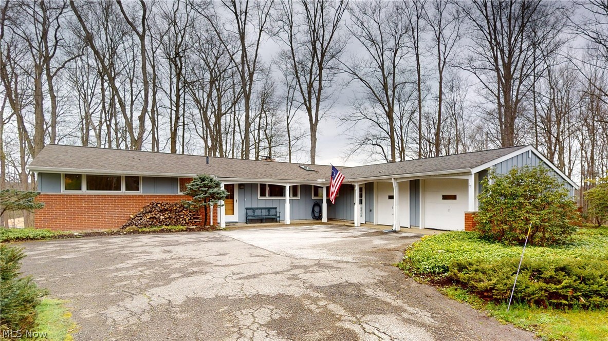 Beautifully updated 4 bedroom/2 full bath ranch with stunning views of the Chagrin Valley and Metro parks The main floor features an updated galley kitchen with beautiful countertops, high end appliances, solid wood floors, large windows of light throughout the main floor. Sliding glass doors off the kitchen/dining room leads to a deck perfect entertaining. The dining room has large floor to ceiling glass windows to take in the view.. Adjacent to the dining room is an open living room with fireplace and vaulted ceiling. The home also provides relaxation of an additional cozy 4 season room with bookshelves, wood stove and more views of nature that lead to a separate private patio. Three bedrooms share a hall bath. The primary bedroom recent addition has large walk in closets, sliding glass doors that also open to the private deck. The updated primary bath with his and her sinks and walk in shower. Newer roof, water heater, washer/dryer etc. 2 car attached garage. Home warranty included. Updated Landscapping OPEN HOUSE THIS SATURDAY 4/13 12:00 Noon to 2:00