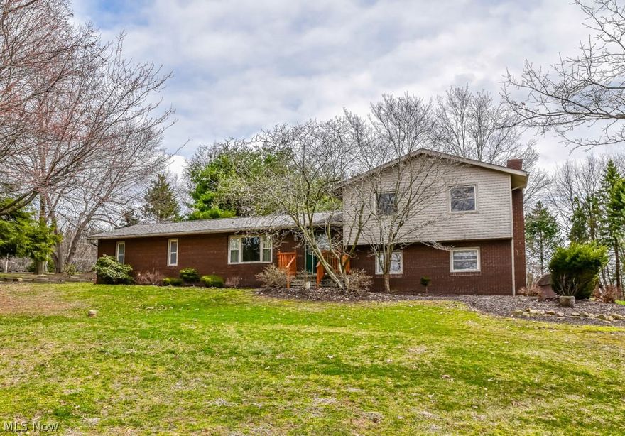 Beautifully maintained 4 bedroom, 2 full bath 4-level split on 2 acres in Northwest schools! Find your culinary inspiration in the enormous kitchen with amazing pantry space, soft-close hardware, stainless steel appliances, solid surface countertops and a breakfast bar. The kitchen opens to the dining room with sliding doors to the back deck. The front living room is filled with sunlight pouring in from the picture window and has been freshly painted. Enjoy a good read by the brick fireplace in the family room on the lower level. Around the corner, the master suite offers 2 closets, a private full bath and sliding glass doors to a side patio. Upstairs, there are 3 additional bedrooms and a full bath with dual sinks. Tons of storage in the basement with laundry hookup, a new wash sink and walkout access to the 2-car rear load garage with Nature Stone flooring! You'll love spending your summers outside relaxing on the multi-tiered deck featuring a pergola with a swing. The park-like yard