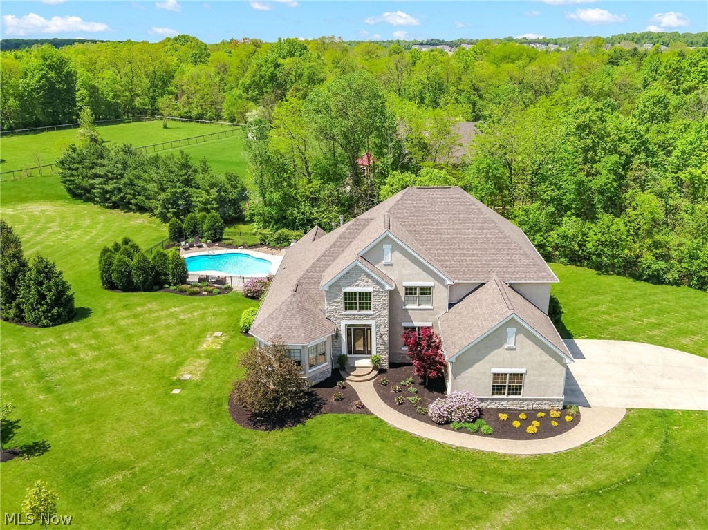 Dublin Schools - Showings start Saturday at 2pm.Stunning modern custom built home on 1.5 acres with woods, ravine and heated in-ground pool. Over 6,700 sqft of finished living space - 5 Bedrooms and 4 Baths, finished walk out Lower Level with media room, game room, gym, bedroom & full bath. 2 story great room showcases stone fireplace with reclaimed wood mantle, wall of windows and built-ins. Large island kitchen with SS appliances, walk-in pantry, large vaulted sunroom opening to deck overlooking covered patio, fire pit and pool. 1st floor vaulted master suite with large walk in closet, spa like bath with his and her vanities, and separate soaking tub. Ready to move in with new carpet, luxe lighting, new backsplash, freshly painted interior and exterior. Close to Bridge Park, Historic Dublin, Glacier Ridge,Tartan Fields GC & Muirfield CC.