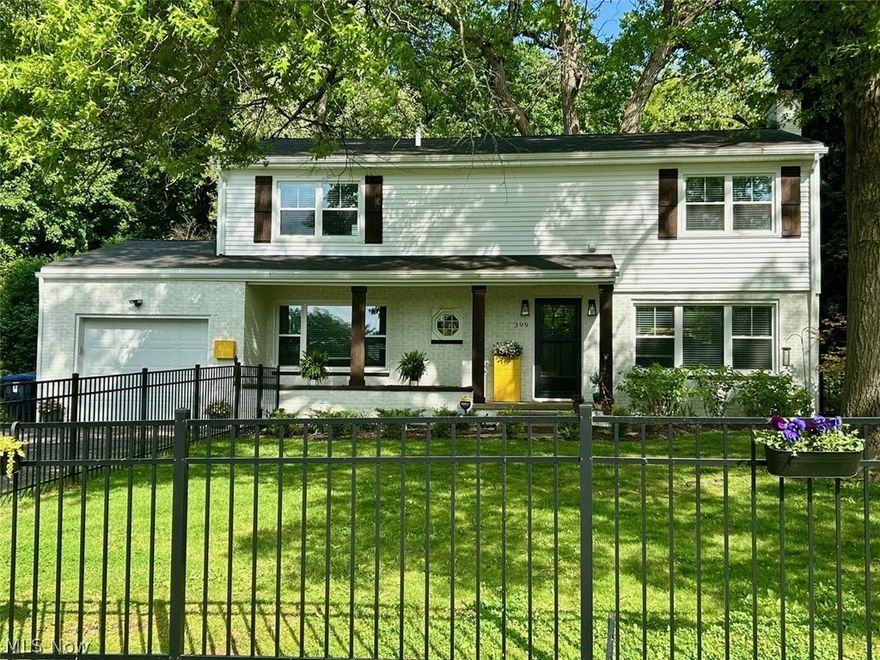 Fall in love with this classic West Akron Colonial Home sitting on 0.22 acres on a tree lined street. This home is surrounded by beautiful mature trees with a large concrete back patio (9x30) overlooking this serene back yard. New black aluminum fence in the front yard was installed in April 2025, featuring two oversized gates for easy access to the front walkway from the driveway or through to the backyard. Walking distance to Parks, playgrounds, restaurants, grocery stores, library, and other entertainment. Easy access to I-77. This 4-bedroom, 2.5-bath home has been tastefully remodeled over the last 2 years. New kitchen features, quartz countertops, tile backsplash, soft close cabinets with crown molding, recess lighting and tile floors. Flows seamlessly into the dining room with recess lighting, and a stylish Cane Wood Center Table Pendant. Full glass view backdoor off the dining room for easy access to backyard. Expansive living room centered by the stone-faced wood burning fireplace with granite hearth; let the sunshine in with an abundance of large windows covering both North & West sides of the home. Custom blinds throughout. Fully remodeled Half bath and convenient 1st floor bedroom (currently being used as an office) round out the downstairs. Upstairs you will find three generous sized bedrooms, including a large primary that features a custom accent wall, walk in closet and oversized ensuite. Ensuite features tile shower, with custom glass doors, double vanity with quartz counter tops, and built ins. Second full bath includes tub with tile surround and tile floors. Second floor laundry for convenience. Home features all original hardwood floors that have been refinished. Some additional updates include Atlas Gutter Guards (2025), Keyless Entry Front Door (2025), Larson Storm door with retractable Glass/Screen (2024), Whole house Double Hung Vinyl windows, and Adorn mailbox. New Garage Door with opener and keypad.