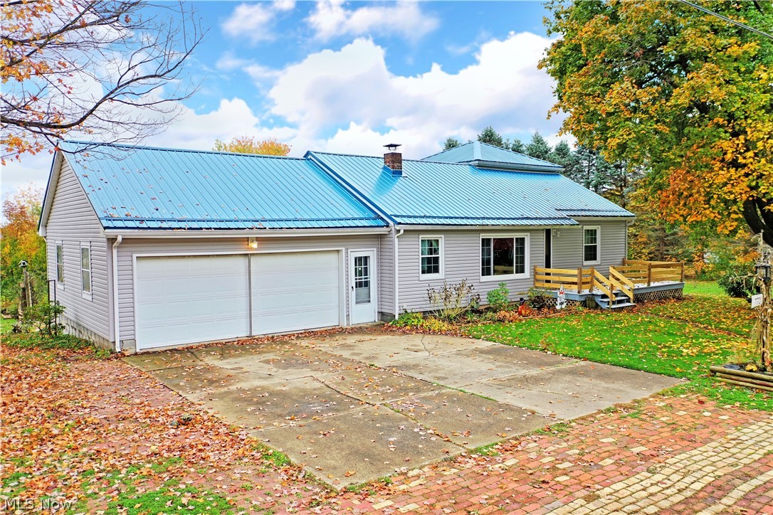 This gorgeous Brookfield home packs cozy, country charm with a modern twist! Easily standing out from the surrounding neighborhood with its bold blue steel roof, the 3 bedroom home continues to both delight and surprise with its relaxing rear patio-scape, 18ft above ground pool, oversized storage shed and lush gardens. The formal entryway lends to a welcoming central living room where hardwood flooring shines beneath the sunlight of the large picture window. Sculpted archways lead down the hall and into the remarkable updated kitchen where white beveled marble tile backsplash is paired with long running gray counters that include bar-top seating. Light ash-colored vinyl flooring continues below into the lovely dining nook where a custom built-in bench surrounds the table. Down the hallway with newly refinished hardwood floors, a pair of sizable 1st floor bedrooms with great closet space can be found. Mid hall, a delightful updated full bath with stunning tile tub/shower surround, bespoke vanity, and country style. A 3rd upstairs bedroom makes for the perfect loft getaway and also gives access to attic storage space. A full basement contains plenty of rec and storage space to include built-in cabinets and an ample laundry area with a lower 2nd full bathroom. Additional features: attached 2 car heated garage, 18ft above ground pool with attached deck built with composite decking and a vinyl railing, metal roof/vinyl siding/gutters 2015, newer windows throughout, and HWT 2018.