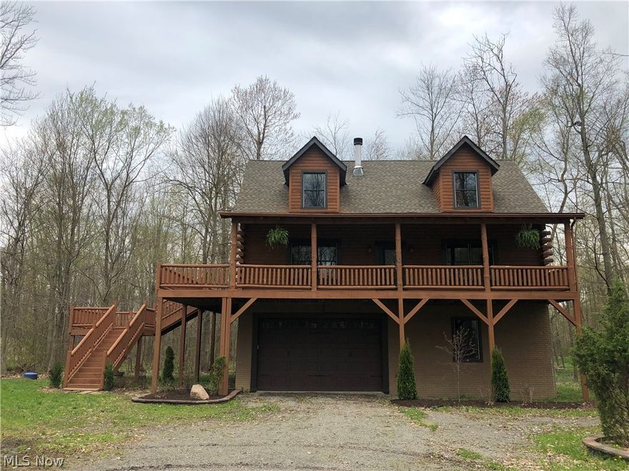 This beautiful red cedar log cabin with wrap around porch and sits on 10.6 acres. It is beautifully finished and features a great room with a stone wood burning fire place. The kitchen is done in hickory cabinetry and will sell with all appliances. The cabin has 3 bedrooms and 2 & 1/2 baths, including a jacuzzi in the Master Bathroom. These owners have finished out the interior and cleaned up the property. The property is mostly wooded, has 2 ponds and  a firepit area. Although next door to KC's Rifle Pistol Club, this property has a lot to offer to anyone looking for a weekend retreat.