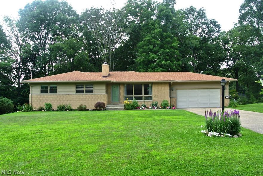 Curb appeal, beautiful landscape, 3 or 4 bedrooms, 3 full bathrooms, and in-law suite, attract you in to this home! The remodeled eat-in kitchen features granite counters, stainless steel appliances and is open to the family room, living room and dining room.  The spacious living room features hardwood floors, wood burning fireplace and large picture window.  The unique walk-out basement has a kitchenette w/eating area, additional bedroom, living room w/fireplace, full bathroom, storage room and laundry area.  A 2 car attached garage, 2 patio areas, numerous updates, and a fabulous location add to the many reasons you will want to see this home.  Close to: grocery store, post office, restaurants, park, schools, freeway and much more.  Call today for more details.