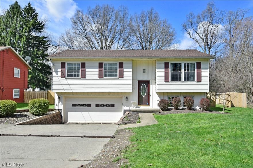 Don’t hesitate, this gorgeous Howland bi-level isn’t going to last long! Showcased in its expertly decorated rooms, this welcoming residence offers tons of style through tasteful design elements such as stunning flooring choices, sliding barn style doors in the hall and lower bath, and updated lighting fixtures. A sun-filled foyer leads you past a tiled landing and up to the main floor where the large picture windows fill the relaxing living room with natural light. Rustic flooring choices run below and continue down the main hall. The open dining area awaits nearby as French doors lead out to the elevated rear patio space. Large ceramic tile work pairs well with the accenting backsplash, stainless appliances and stark white cabinetry to complete the kitchen. Three spacious bedrooms reside on the main floor, joined by a handsome full bath. Downstairs garage access is located near a second full bath with tiled stall shower. The finished lower family room offers plenty of space to entert