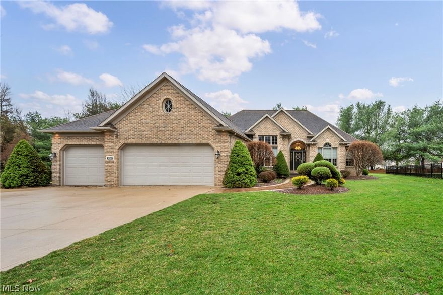Welcome home to 3302 Ashton Drive, a STUNNING all brick ranch in pristine condition in the Green Local School District! When you pull onto the cul de sac, you will be drawn to the gorgeous grand exterior with perfectly manicured landscaping featuring an arrogation system and rock beds for a maintenance-free upkeep. The walkway into your new front porch is an extra wide stamped concrete leading you to a covered arched entryway. Step inside and be in awe of the beautiful woodwork and extra high ceilings on this open concept home. The living room is spacious and features a warp around fireplace, making it visible from the 4 season sunroom. This space has natural light pouring in from each window and allows access to your private concrete stamped patio and spacious backyard. The eat-in kitchen features an abundance of granite countertop space and impeccable wood cabinets. The master suite is AMAZING with an extra seating area, huge walk-in closet, an extra large shower with built-in seating, soaking tub and his and her sinks. An office space (or could be formal dining/playroom) is conveniently located just down the hall next to 2 bedrooms and a full bath. The huge mudroom/first floor laundry room is just off your 3 car attached garage. The architecture in this home is unreal and has to be experienced in person!  The basement is massive with high ceilings and ready for your finishing touches. This home is moments away from the areas' best golf courses, shops, highway access, and more! A brand new roof will be installed in April before close! Additional updates include whole house generator, new furnace (2025- with 10 year transferrable warranty), gutter guards 2023, new garage door openers (2025) and more. This community offers pavilion space, playground and walking track. Do not let this one get away! Call today to schedule your private showing!