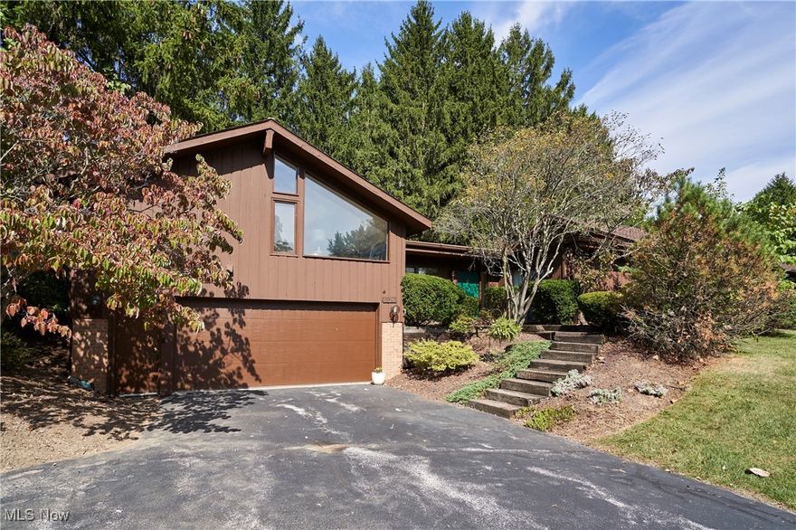 Step into this rare, sprawling, exquisitely designed condo privately located in The Pines. Every inch of this home has been maintained and upgraded with true consideration. When you walk in the front door, you'll immediately see this is not your average condo. New luxury vinyl flooring has been installed throughout the center living area, currently being used as a sitting area and den. The wide open area will undoubtedly be the perfect spot to entertain and host guests. A bonus is the Sound System that can be used to play music, news, or sports throughout the home! With natural light surrounding you, and a large, 2-sided, wood-burning fireplace, you'll feel secluded and cozy. Head to the right of the living room where there are 2 bedrooms. The guest room also has a sliding glass door allowing for a naturally lit atmosphere. There is also a full bath just next to the guest bath. Around the corner is the primary suite. This massive 19x13 room has a thoughtful accent wall, access to the back porch, and a newly updated full bathroom. You'll appreciate the upgrades as you walk through. Head to the oversized kitchen with a breakfast bar for that quick on-the-go meal, or space for a large dining room table where you'll be able to enjoy even more views of the woods behind you and the other side of the fireplace. All appliances are staying with the home, making this a true move-in-ready opportunity. Head up a few stairs to the loft space which offers endless opportunities. Use this as a bedroom, office space, lounge, gaming room, or whatever your heart desires. A few steps down is the laundry area, which is still close yet secluded. A large 2-car garage gives you space for storage and parking alike.  There is also a driveway extension that allows for extra parking, and the ability to back in and out easily! Call this place home with low maintenance and easy living. Schedule a private tour today!