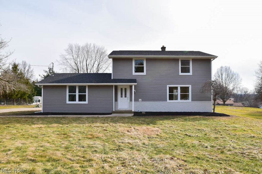 Completely remodeled 4 bedroom colonial with a 3-car garage on nearly half an acre! Lovely curb appeal with brand new siding and windows. This bright, inviting home offers spacious living areas with new flooring and fresh paint throughout. Find your culinary inspiration in the beautiful kitchen with new white cabinets, subway tile backsplash, stainless steel appliances, a breakfast bar and a pantry. The kitchen opens to the dinette with sliding doors to the back patio. Gather in the huge, sun-filled living room or cozy up next to the fireplace in the massive family room addition. Convenient half bath on the main level, too. Upstairs, there are 4 bedrooms and an updated full bath with a linen closet and new vanity. Need even more space!? The lower level offers a finished rec room that boasts a gorgeous dry bar. This is the perfect entertaining area! The unfinished side provides lots of storage as well as a new furnace and hot water tank. Fantastic backyard with a patio to enjoy the summ