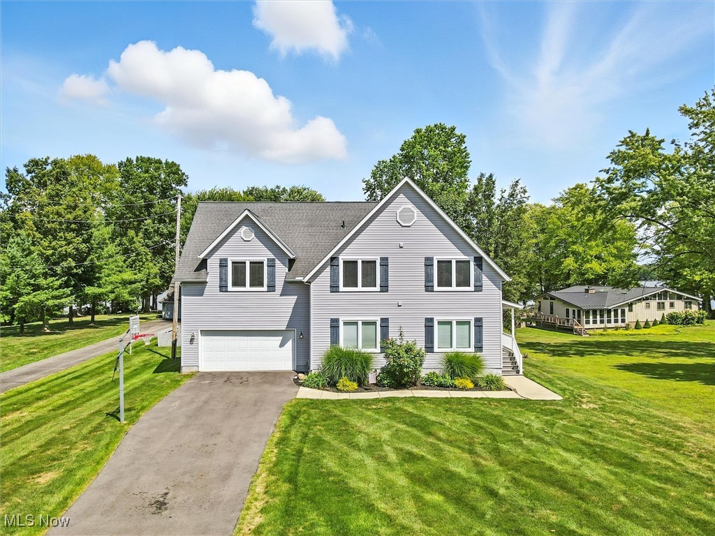 This breathtaking 2-story lakefront retreat combines modern design with cozy comfort and sweeping water views. The dramatic great room features soaring 2-story floor-to-ceiling windows, an open-concept kitchen, and a gas fireplace, all overlooking the beautifully landscaped yard that gently slopes to the lake.
The first floor offers a 2-car attached garage, convenient laundry room, two spacious bedrooms, and a full bath, along with a full unfinished basement perfect for storage. Throughout the home, you’ll find all new paint and flooring, giving it a fresh and move-in-ready feel.
Upstairs, the open loft office area provides a spectacular view of the lake, while two additional bedrooms share a Jack-and-Jill bathroom. Either bedroom can serve as the primary suite, with the larger room currently set up as a game room featuring two queen bunk beds—ideal for guests and entertaining.
Recent updates include a newer furnace, hot water tank, updated plumbing and electric, new sump pump, resurfaced driveway, replaced deck boards with fresh stain, and more—ensuring peace of mind for years to come.
Step outside to enjoy the expansive deck, beautiful cement patio with gas grill, boat lift, and double jet ski ramp—all perfect for making the most of lakefront living.
This home is the perfect blend of luxury, function, and lifestyle—a true lakefront dream!
