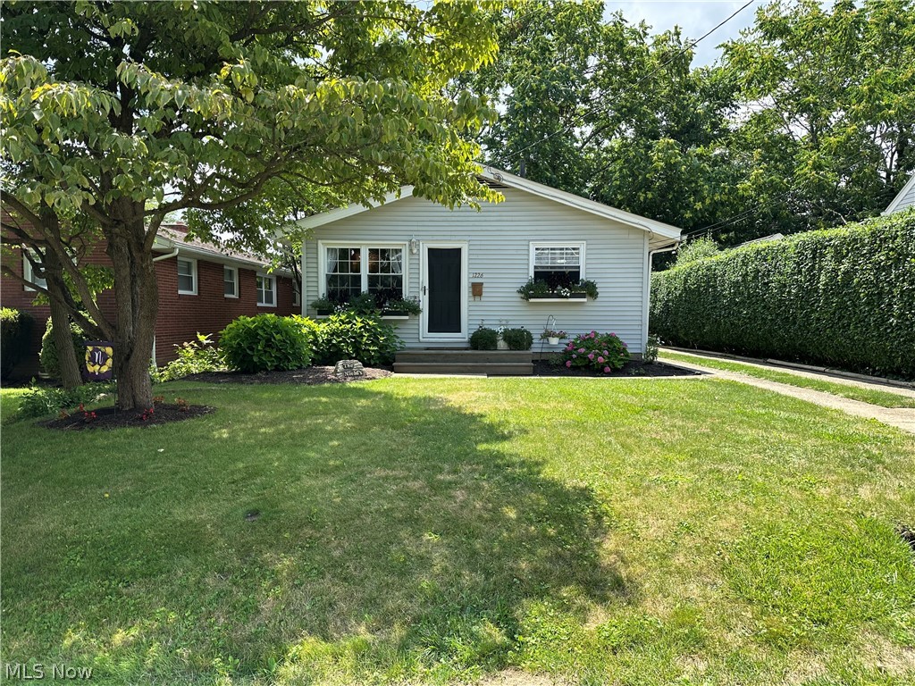 Welcome to 1226 28th St NE! With 3 bed/1 bath this beautifully decorated ranch home that feels like home! The front yard features a charming porch, window boxes, a dogwood tree and hydrangeas. Enter through a glass screen door into a cheerful family room with bright windows. The airy white kitchen has new hardware, updated countertops, beadboard walls, laminate wood flooring, and a spacious dining area. The remodeled main bath includes white bead board walls, a new tub surround, frosted glass, a new vanity with marble countertop. Bedrooms have hardwood floors, white trim, double-hung windows, and ceiling fans. The full basement features painted walls and glass block windows, perfect for activities. The fenced-in backyard includes a 6-foot privacy fence and ample space for relaxation and entertainment. Many updates throughout the years! This home is easy to love! Schedule your tour TODAY!