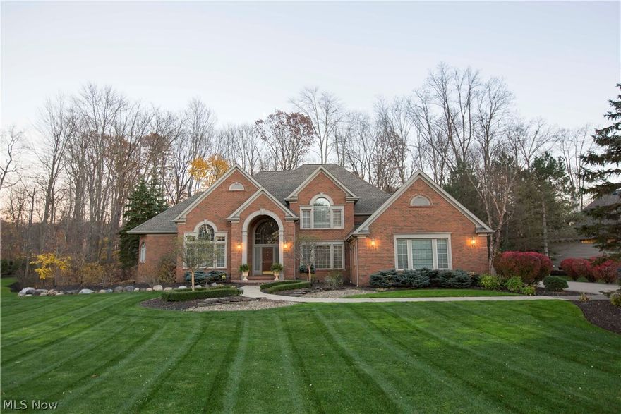 Beautiful brick colonial, completely updated & move-in ready with new carpet, newer roof and high-efficiency furnace and AC. Over 6000 sq ft of total living space, including the finished basement. Modern, open floor plan with 2-story foyer & Great Room which features walls of windows, gas fireplace. Remodeled kitchen features lots of high-end cabinets, solid-surface counters, custom back splash, gas countertop range, double oven (GE Monogram & Viking appliances), eat-in area which opens to a hearth room with fireplace & doors to the private deck & enclosed porch. 1st floor master suite has vaulted ceilings, luxurious bath with dual sinks, separate shower, jetted tub, private commode room, vanity seating area, multiple closets including a spacious walk-in. 3 more huge bedrooms upstairs, one with a private bath, 2 more sharing a Jack-n-Jill bath. The basement has an additional living area, built-in wet bar, recreation area, office, workout room, plus a separate suite (5th bedroom) with i