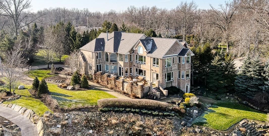 Stunning Lake Erie residence on private .98 acre lot. The deep set back and mature landscaping afford exceptional privacy. Full brick. Fine quality. Replete with amenities. Water access, revetment, dock, boat lift and downtown views. Elegant but unpretentious. A gracious and welcoming home. The grand entry is highlighted by Its fabulous flowing floor plan is ideal for entertaining. Classic, neutral (but never boring) decor. High volume ceilings. Outstanding architectural detail delineates the great room (with massive fireplace) dining room, living room and family room – all open to the gorgeous “cook’s kitchen” (with two islands, prep sink, two double Wolf ovens, 6 burner gas Viking stove with char-grill station, Sub-Zero, wonderful walk-in pantry and more.) The 1st floor also boasts two extraordinary adjacent offices & a North facing lake room. Two staircases lead to the lofted upper level. Exquisitely crafted rich warm wood trim-work throughout. The upper level features a spectacular
