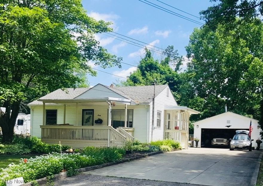 Charming 3-bedroom, 2-bath home ready for your personal touch! Enjoy the best of three seasons on the inviting front and back porches. The eat-in kitchen opens to a spacious rear porch through sliding patio doors—perfect for relaxing or entertaining. Original hardwood floors run throughout the living room and bedrooms, adding warmth and character.The back porch overlooks a nice backyard, and the property includes a two-car garage with a concrete driveway. The basement features a full bathroom and a convenient mini-kitchen, offering great potential for additional living space. Located close to shopping and restaurants in a delightful neighborhood of well-maintained homes, this property has so much potential. Tallmadge Schools! With a bit of TLC, this gem could be the ideal starter home!