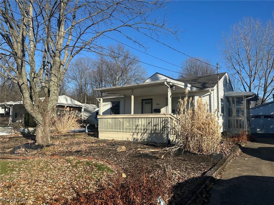Charming 3-bedroom, 2-bath home ready for your personal touch! Enjoy the best of three seasons on the inviting front and back porches. The eat-in kitchen opens to a spacious rear porch through sliding patio doors—perfect for relaxing or entertaining. Original hardwood floors run throughout the living room and bedrooms, adding warmth and character.The back porch overlooks a nice backyard, and the property includes a two-car garage with a concrete driveway. The basement features a full bathroom and a convenient mini-kitchen, offering great potential for additional living space. Located close to shopping and restaurants in a delightful neighborhood of well-maintained homes, this property has so much potential. Tallmadge Schools! With a bit of TLC, this gem could be the ideal starter home!