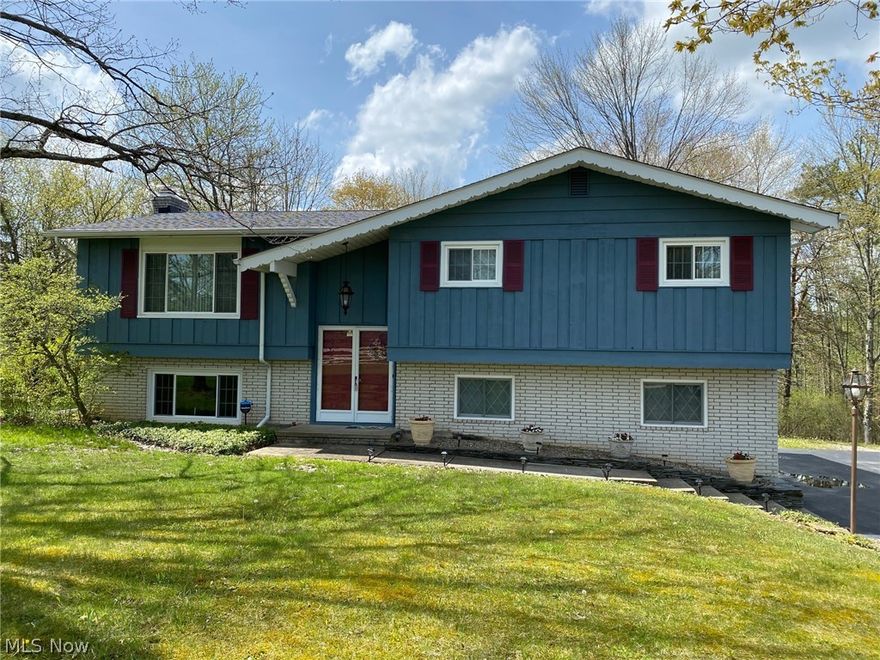Updated 3 Bedroom & 2.5 Bath Home with park-like setting! Vaulted Living Room with large picture window open to Dining with new sliding glass door to deck overlooking wooded backyard. Kitchen with newer appliances and wood laminate floors. All 3 bedrooms have hardwood floors including Master with double closets and private full bath. Lower level includes Family Room with brick wood burning fireplace, laundry room & half bath. Many new light fixtures throughout. Newer roof, gutters & vinyl windows. Paved driveway & 2-car attached garage. Community well & sewer. Situated in Kimberly Estates on quiet cul-de-sac street. West Geauga School System. 1-yr home warranty.