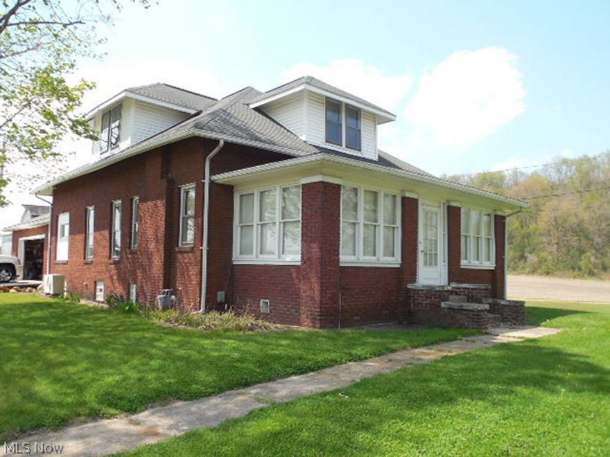 If  your are looking for 4 acres just outside of town this is just what you are looking for. This is beautiful level acreage with several out buildings including a barn. Included is a large 2 story brick home with 5 bedrooms living room dining room and eat-in kitchen. There is an enclosed front porch with hardwood floors and an attached garage. There is a detached man cave with all the comforts of home. This property has been owned long term by present owners but health reasons has made it necessary to leave the home they love. You can be the next owner of this gracious property.