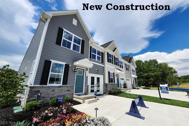 MOVE IN READY! 15 YEAR TAX ABATEMENT! END UNIT – FIRST FLOOR LIVING This first floor living townhome is surrounded by the Cuyahoga Valley National Park!! Enter your brand new home through the one-car garage and step right into the gorgeous gourmet kitchen with granite countertops and included stainless steel appliances. The huge center island overlooks both the inviting great room and the formal dining space. Entertain family and friends here or outside on the included covered outdoor patio. The main level also includes your luxury owner’s suite, which features a dual vanity bath and huge walk-in closet. Upstairs, you’ll find two spacious bedrooms, a full bath, and unfinished storage that is huge. Enjoy the gorgeous community center which is another home away from home with fitness center and pickle ball courts with outdoor living area as well! You need to see this to believe it! Schedule an appt today.