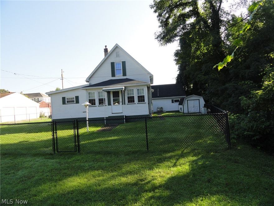 Adorable cape cod on quiet street with extra lot.  Master bed on main level, circular flow through dining, kitchen, breakfast nook/laundry.  Spacious rooms throughout.  2 additional bedrooms upstairs.  Yard fenced with good chain link fencing, ready  for kids and dogs.  Large screen room for 3 season comfort.  Detached garage with storage above, plus a backyard workshop/shed.  Per seller, hardwood flooring under carpet in dining and living rooms.  Great starter home, can move right in, and update to your taste on your timetable.