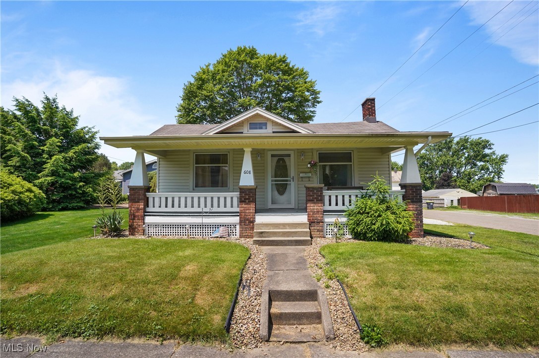 This charming home sits on a corner lot and offers a gorgeous front porch to enjoy as well as a side porch, a rear sunroom and a back deck. An awning covers a patio attached to the garage. Plenty of spaces to enjoy the outside. Walk into a beautiful living room with a gas fireplace original hardwood floors throughout, dining area with built in as well as two bedrooms and one full bath, all on the first floor. Stunning updates completed in this home in April 2025. A cement drive leads into the detached two car garage. A room in the basement has been turned into a workshop, basement has been completely redone. No waiting no guessing just move right in and enjoy. Whole house has been painted and a gorgeous kitchen with new cabinets and countertops. This home is truly turnkey and ready for you to enjoy from day one don’t miss your chance to own this charming gem. Schedule your private showing today!