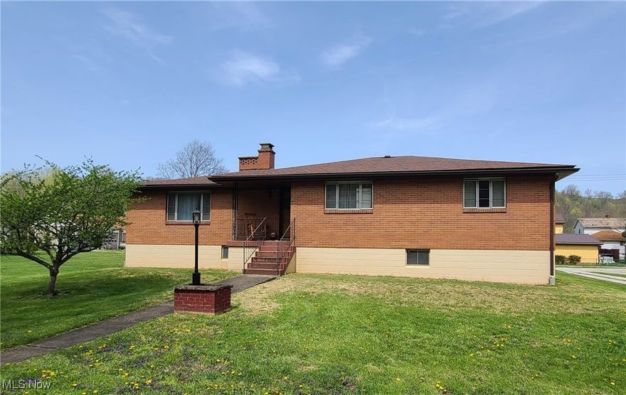 Welcome to this charming brick ranch nestled on a spacious, nearly half-acre in-town lot! This well-maintained, single-story home offers over 1,515 square feet of comfortable living space with three bedrooms and one and a half updated bathrooms. Enjoy beautiful hardwood floors in the living room and bedrooms, complemented by easy-care laminate flooring in the kitchen and dining areas. The home features a roomy 21x24 carport, easily accommodating two vehicles. Step outside to a large, level yard adorned with a lovely apple tree and a grape arbor—perfect for enjoying the outdoors. With public utilities, a roof that's approximately nine years old, and thoughtful updates throughout, this home is move-in ready and waiting for you!