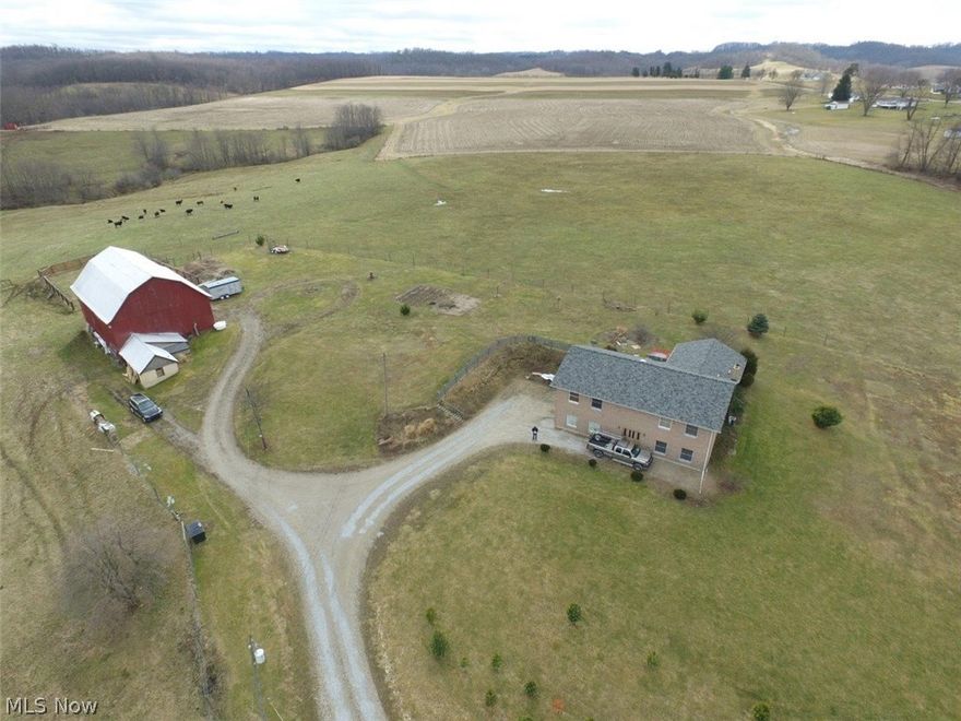 You'll be smitten by this beautiful country property with it's amazing panoramic views on this grand, private 7 acre hillside site. The stunning 40 x 60  red barn can be seen as you approach. It has three levels including a mezzanine and an old milking parlor attached. Fenced acreage. This is an all brick 3 bedrooms, 2 bath ranch home with an exposed basement, open staircase, 5 ' hallways, poured concrete walls, steel beam construction, new roof (2014), new  Anderson 400 series windows from Keim (2014), deck off the dining room, hot tub, and small fish pond for outdoor relaxing. This large custom eat-in kitchen opens to the formal dining room with designer wood floors. The Texas size master Suite with a walk-in glass block shower and tiled floors with separate jetted jacuzzi tub. A third bedroom is located in the lower level along with a full bath, 16x11 furnace room and a 24x19 utility room/wood burner. 2 car attached garage.