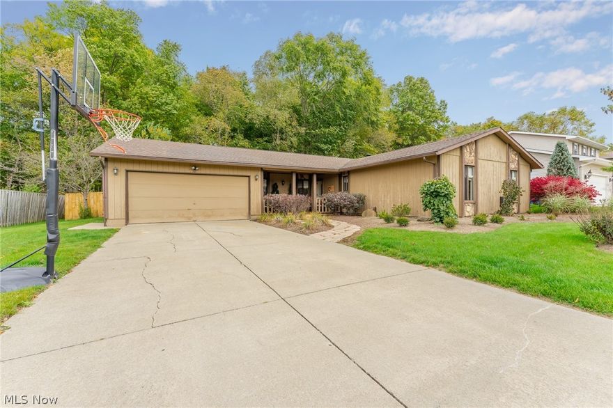 Beautiful, updated ranch with three bedrooms, 1-1/2 baths, living room and sweet sunroom leading to multi-level deck, fenced in back yard and wooded park view!  Kitchen features new in 2019 - Bright, light cabinets, countertops, backsplash, hardware, sink and faucet. Breakfast counter has seating for two.  Dining area is a gathering place!  Step down living room features wood burning fireplace leading to heated sunroom with gorgeous views of back yard.  Spacious laundry room.  Perfect office/study niche.  Bedrooms feature plenty of closet space and good storage throughout!   All electric.  Carpeting in 2018.  Freshly painted in calming, neutral tones.  Roof approximately 9-10 years old.  New landscaping, fence and deck in 2020.