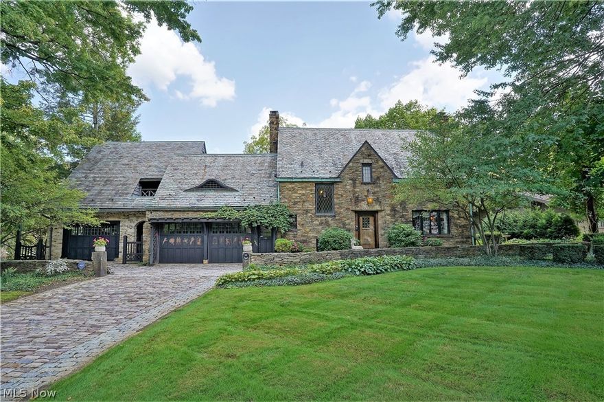 Last sold in 1988, this Silver Lake crown jewel is on the market for only the second time since it was built in 1934 by artist, Mr. A. E. Boedeker (Bodie). The home is rich in architectural history, built in the English Cotswold style, with stone exterior, cobblestone driveway and walkways, slate roof, leaded and stained-glass windows, library with eyebrow window, lake views from nearly every room and gorgeous wood details, some hand-carved by the original owner, including doors, trim, staircase, built-in shelving, antique English corner cabinets, beams, 3 fireplaces, one-of-a-kind garage doors and more. Stepping into this home feels like going back in time in the best possible way; homes simply are not built like this anymore. In 2000, the home’s owners embarked on a tasteful, historically sensitive addition using wormy chestnut to match the original wood. The addition includes an eat-in, open kitchen with quartzite counters and Viking range, spacious great room, glass Amdega conserva