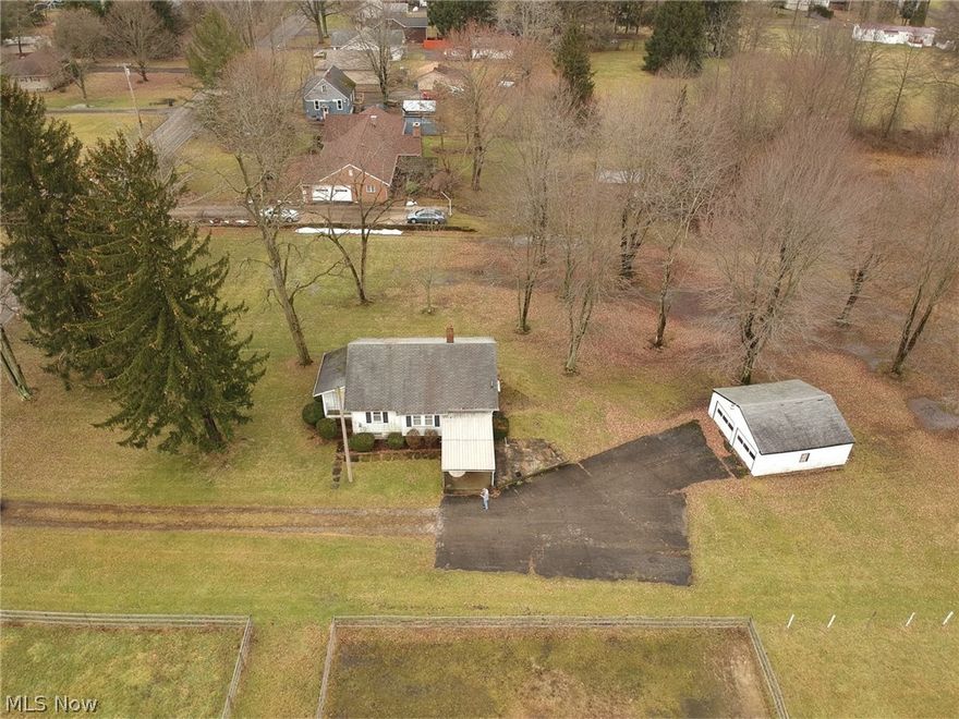 Country Living yet close to everything! Ranch home with large open living/dining area. Galley kitchen. 1st. floor laundry. Covered porch. All on 7.76 Acres! 2 Parcels. Walk out basement. Newer windows, 24x24 detached garage. Sold "AS IS".