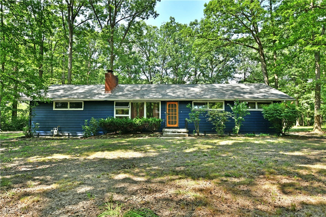 Have you been on the hunt for something a little different? How does scenic natural seclusion sound? What if I told you it was just minutes away from various, highly desirable local attractions and easy freeway access for those daily commutes? Look no further, this potential packed Mineral Ridge ranch checks all the right boxes as it offers up a unique opportunity that you won’t find every day. The densely tree lined lot creates a leafy veil of privacy, opening to showcase the bold blue home, instantly grabbing your attention for added curb appeal. A park-like backyard enjoys a raised rear deck and a covered patio section that join a bonus storage shed, tucked away nearby. Inside, the colorful living room showcases a stone lined fireplace as formal dining stretches away with its decorative lighting. The central kitchen host plenty of cabinet and countertop space as wooden cabinets provide a warm accent. Meanwhile, a half bath hides around the corner near basement entry. Around the corner, the main hall outstretches to find an immediate trio of colorful bedrooms, each with hardwood flooring. A deep-set full bath sits at mid hall, providing pass through access to the oversized, rear master bedroom; bringing the total to four. At the basement level, laundry accompanies bonus rec space and storage to include a second fireplace. Call today for more!