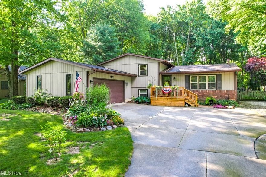 **Open House that was scheduled for 9/3 at 12pm is CANCELLED* Enchanting 3 Bed/2 Bath spacious split-level home minutes away from KSU and NEOMED! The main level features wood-look laminate flooring, a formal living room, an eat-in kitchen with stainless steel appliances, beverage center, farmhouse sink, Quartz countertops, ceramic tile backsplash & a Great Room full of rustic touches such as wood beams & a woodburning stove that are reminiscent of a warm and cozy lodge. Head upstairs to the second level where you will find three carpeted bedrooms & a full bath w/access from both the hall & Master. Down a few steps to the lower level is a family room featuring a brick gas fireplace, laminate wood-look flooring, a 2nd full bath & laundry room with washer/dryer that remain with the home. Down another level to the basement is a large carpeted rec room. You'll never want to leave this charming home with its lush and private backyard space! Entertain your guests on the covered patio which can be accessed directly from the Great Room or take a few steps down to the oasis-like brick paver & stamped concrete patio with plenty of shaded nooks for enjoying a book. The hobbyist will appreciate the huge shed and unique workshop that is wired for electricity & heat, plus the whimsical treehouse that is also wired for electricity & features a loft and wrap-around deck. Roof and HVAC (with UV light air purifier) have been replaced within the past 10 years! Home warranty included.