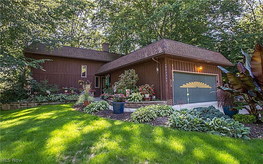 This modern cedar-sided 4Bed/3Bath beauty is intriguing with its open staircase, exposed fireplace stone & cedar highlights in the vaulted entry, 2-story living room with catwalk & unique rear-windowed design (creating front privacy and a beautiful view of the back yard). Kitchen & dining area gutted & expanded in 2008 & boasts: ash Custom Cabinets (two with dimpled glass); high-end KitchenAid appliances (including convection microwave); Cambria quartz countertops; earth tone mini subway tile backsplash; pendant lighting above uniquely-shaped island; beautiful laminate flooring. Among other outstanding features is the gorgeous exterior walkway/entry, rustic lower level room with Nature Stone (2015) & authentic barn siding/beams (including several surprise "flush" doors to other areas), first floor laundry, private back yard, surround-sound system, MORE! Located in an established neighborhood & CONVENIENT to: Tallmadge Circle & connecting points; Maca Aquatic Center; Tallmadge Rec Cente
