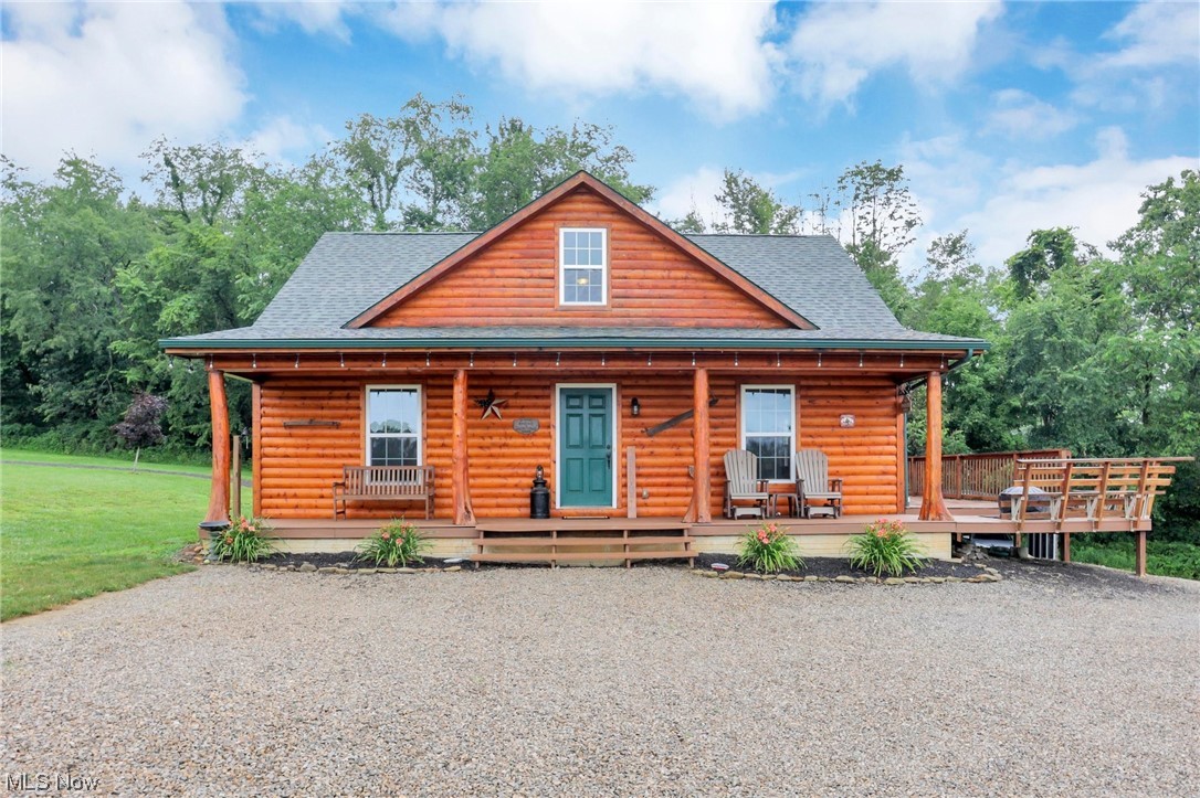 WELCOME HOME! Perched high on a Perry County plateau resides this 17 acre piece of Heaven on Earth! 3 bedroom, 2.5 bath stick built, log sided home. Expansive wrap around porch & deck provide breathtaking views of the surrounding landscape & morning sunrises. Entry into the living room & open kitchen w/island and eat-in space. Entry level primary bedroom w/attached bath & walk-in closet. Laundry area leads to the rear multi-seasons room. Two bedrooms and a full bath on the 2nd level. Lower level offers ample storage & half bath "outhouse", Walk-out basement can be finished for additional living space. Multiple out buildings w/electric & water. Main building w/3 horse stalls & hay loft. 5 acre fenced pasture & 8 acres of woods on a very private setting. 20 min drive to the waters of Buckeye Lake. New outdoor wood furnace boiler for supplemental heat & hot water. Washer & Dryer stay (new 2022). Actual sqft 1,529.