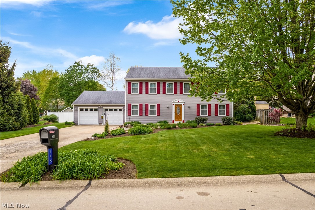 Welcome to the most picturesque home in Munroe Falls. This large, colonial-style home is just over 2,350 square feet and has 4 bedrooms and 2.5 bathrooms. This home offers a spacious layout with many windows providing natural light throughout. You’ll love the floor plan with lots of open living space, but some division for privacy between rooms. The modern kitchen features a huge island with bar seating for 4 people. Sliding doors off the kitchen will lead you out onto a large custom brick patio with ample space for outdoor entertaining. The immaculately landscaped outdoor space is truly breathtaking. With over a third of an acre, the spacious yard provides great privacy with mature trees, shrubbery, and fences lining the perimeter. Back inside the house, the kitchen opens to a spacious living area which boasts a beautiful, traditional wood and brick fireplace. The formal dining room is large enough to fit a table for the entire extended family. The first floor also has a large bonus r