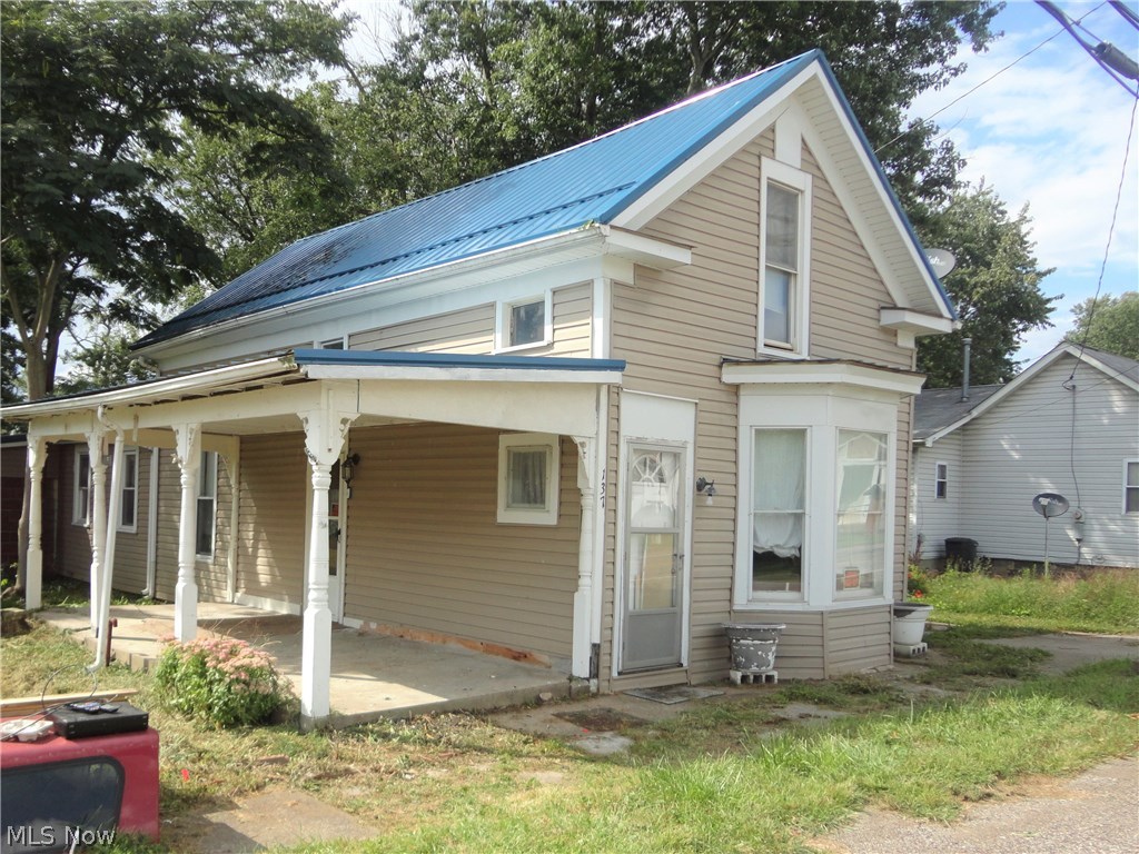 This could be the cutest little "starter home" or "rental property" with a little TLC!! It already sits in a quiet little neighborhood on a lot with matured trees and is less than 15 minutes from St. Clairsville! Featuring over 1800 square feet with high ceilings, this 1 1/2 story Cape Cod has 3 bedrooms (one captured); 1 bath, an "eat in" kitchen (refrigerator and stove stays), a living room and workshop/utility room. The roof and siding are newer, the electric has been updated and most of the windows have been replaced. Opportunity just waiting!