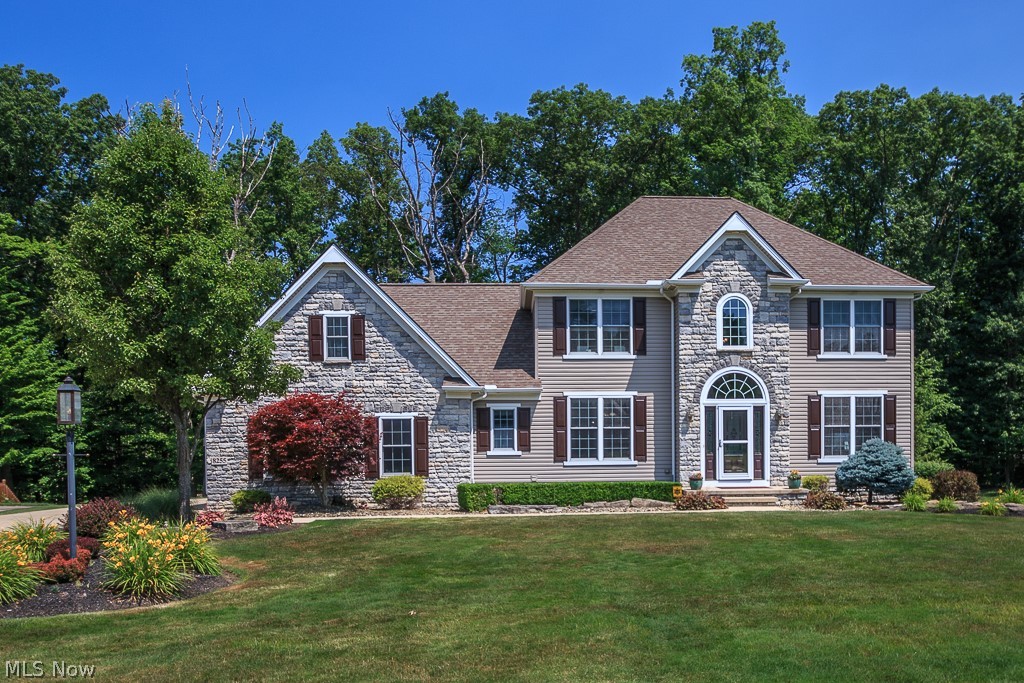 Stunning 4 bedroom, 4 full bath upgraded home on a private wooded lot in Concord Twp! Gorgeous great room w/ a stone gas fireplace, wood beams & plenty of natural light. Eat-in kitchen features granite countertops w/ bar-top seating, updated cabinetry, double trey ceiling, plenty of storage in the huge island, pendant lighting, pantry & all stainless steel appliances stay including the double ovens! Inviting dining room is perfect for entertaining & also has a trey ceiling & arched entryways. 1st floor laundry & office w/ french doors. Upstairs has so much to offer starting out with the huge master retreat that boasts hardwood floors, built-in wardrobes, walk-in closet & an ensuite w/ double sinks, garden tub, step-in shower & a linen closet! 3 more spacious bedrooms upstairs & a bonus room that can be used as a 5th bedroom! If that isn't enough space- the walk-out lower level will surely impress w/ a recreation room, another full bath, kitchen area w/ wine bar, granite counters & bar-