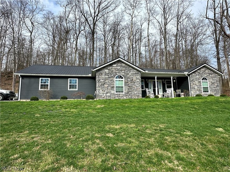 Nestled on 3.95 acres, this beautifully maintained 2019 Built ranch home offers the perfect blend of modern comfort and peaceful country living. Featuring both an attached and detached garage, this property provides ample space for vehicles, storage, or hobbies. Inside, you will find an open and airy layout highlighted by vaulted ceilings throughout, creating a spacious and inviting atmosphere. The home includes 3 bedrooms and 2 full bathrooms, with a generously sized primary suite offering a private retreat complete with a double vanity, walk-in shower, and large walk-in closet. The galley-style kitchen is efficiently designed for everyday living, while a dedicated laundry room adds convenience. Step outside to enjoy the covered front porch or relax on the covered back patio overlooking the scenic acreage, enhanced by a beautiful retaining wall and concrete sidewalks. The home exterior features vinyl siding, attractive rock accents, and a metal roof, combining style and low maintenance. The property offers the ideal mix of functionality, charm, and peace. This is perfect for those seeking a move-in-ready home. All appliances stay with the home, including a water filtering system.  Seller is retaining mineral rights.