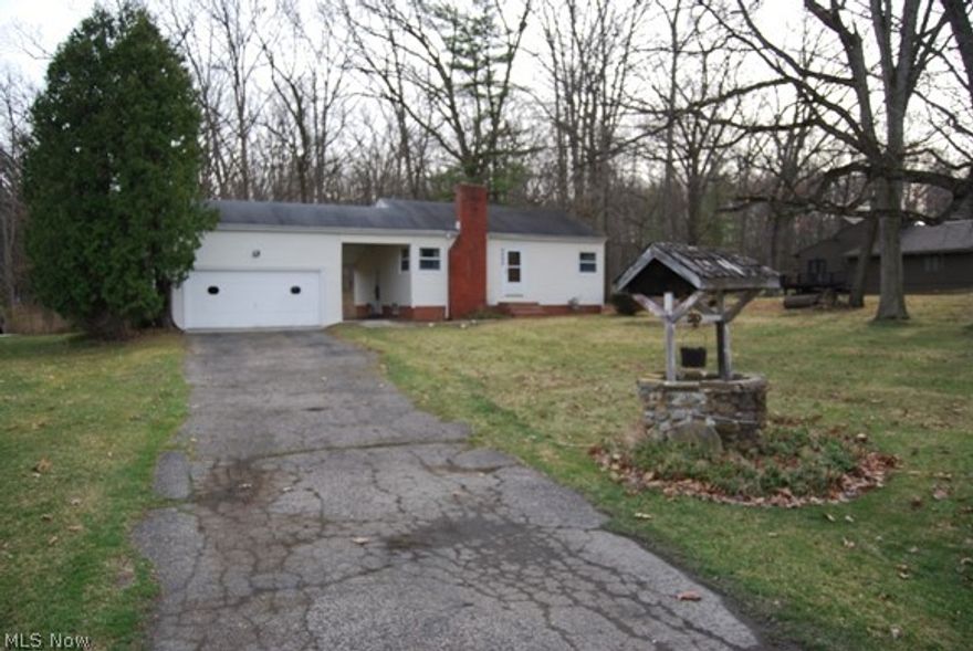 Come and see this cozy home with a peaceful, private, park-like yard with easy highway access. A nature lover's dream. Home has a ton of potential and needs some TLC. Lot is large enough to entertain your friends, add onto the home or build your own. Some of the updates include Andersen Windows, new entrance doors with storms, glass block windows in basement, updated electric box, lights in closets, hot water tank and vinyl siding. Home has two stone fireplaces and hardwood floors in the living room and bedrooms under carpet. Garage has updated electric, storage, water and setup for gas heater. Also has an 11x14 shed. Home being sold as is.