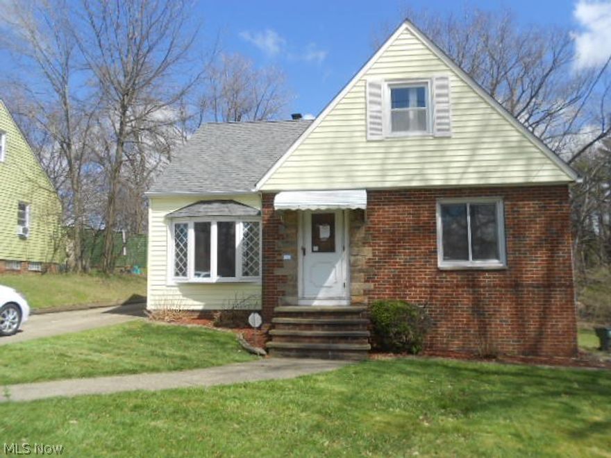 Sharp brick and vinyl sided bungalow priced to sell!  Newer three-dimensional shingle roof.  Nice bay window.  Detached two car garage.  Partially fenced rear yard with deck off the rear of the home.  Large living room with deco fireplace and ceiling accented by ornate wood beams.  Spacious eat-in kitchen.  Modern bath with dual sinks!  Large dormer bedroom up with built-in storage.  Full partially finished basement.  Don't pass this one up!