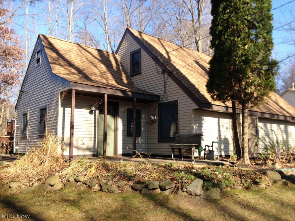 Look at this rare find! Cabin like feel with a private wooded lot. Almost everything inside and out has been remodeled or updated. New flooring throughout, new kitchen with all new appliances, new updated bathrooms, new roof(2012) & new siding(2014). The home has an open floorplan featuring a wood pellet stove in the dining room, a fireplace in the living room and an open modern staircase with an skylight above and opens to the vaulted ceiling. Upstairs bedrooms have vaulted ceilings with open rafters for a one of a kind look. Master bedroom walks out on to the back deck and to the swimming pool. 2 car attached garage + 2 car detached garage/barn with 2nd story. Perfect house for entertaining. Plenty of parking on the driveway leading to the detached garage. Everything is done so get ready to relax and enjoy. Don't miss your opportunity to own this great home. Call today to schedule your showing!