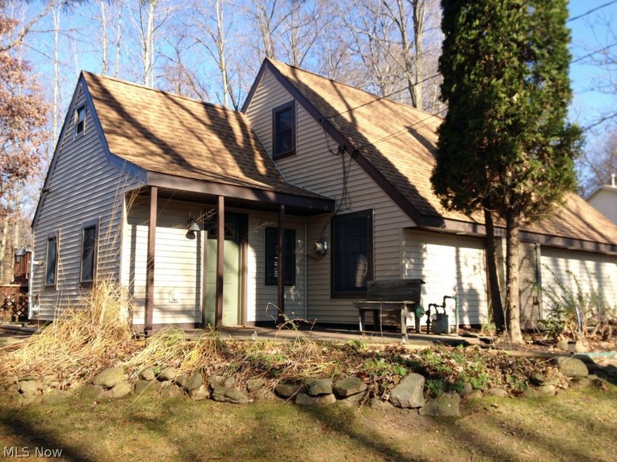 Look at this rare find! Cabin like feel with a private wooded lot. Almost everything inside and out has been remodeled or updated. New flooring throughout, new kitchen with all new appliances, new updated bathrooms, new roof(2012) & new siding(2014). The home has an open floorplan featuring a wood pellet stove in the dining room, a fireplace in the living room and an open modern staircase with an skylight above and opens to the vaulted ceiling. Upstairs bedrooms have vaulted ceilings with open rafters for a one of a kind look. Master bedroom walks out on to the back deck and to the swimming pool.  2 car attached garage + 2 car detached garage/barn with 2nd story. Perfect house for entertaining. Plenty of parking on the driveway leading to the detached garage. Everything is done so get ready to relax and enjoy. Don't miss your opportunity to own this great home. Call today to schedule your showing!