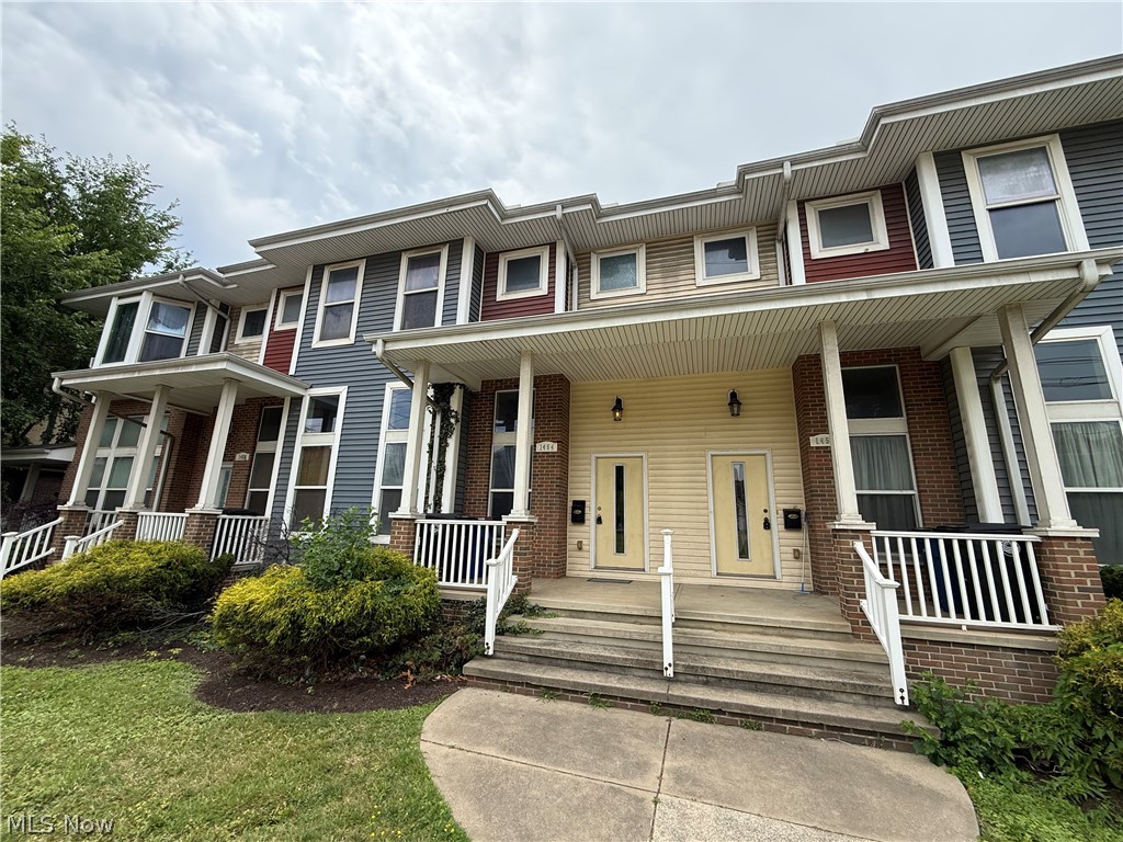 Front of structure. Townhome with multi-colored siding.