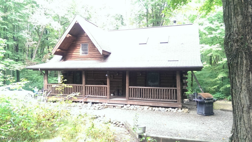 Nestled in the woods, this log home sits on almost 5 acres. The spacious front porch welcomes guests into this rustic, secluded log home built by Walnut Valley Log Homes. Inside a vaulted ceiling large great room welcomes you, with a wood/coal burning stove to keep you warm in the winter. Many handcrafted rustic features throughout this home. Two outbuildings on property, one 24'x40' with elec, and one 12'x20' with electric provide lots of storage. Full, partially finished lower level. Overlooking relaxing front porch is a small pond. Loft area overlooking great room could possibly provide an option for a 3rd bedroom. Call today for a showing of this great home.