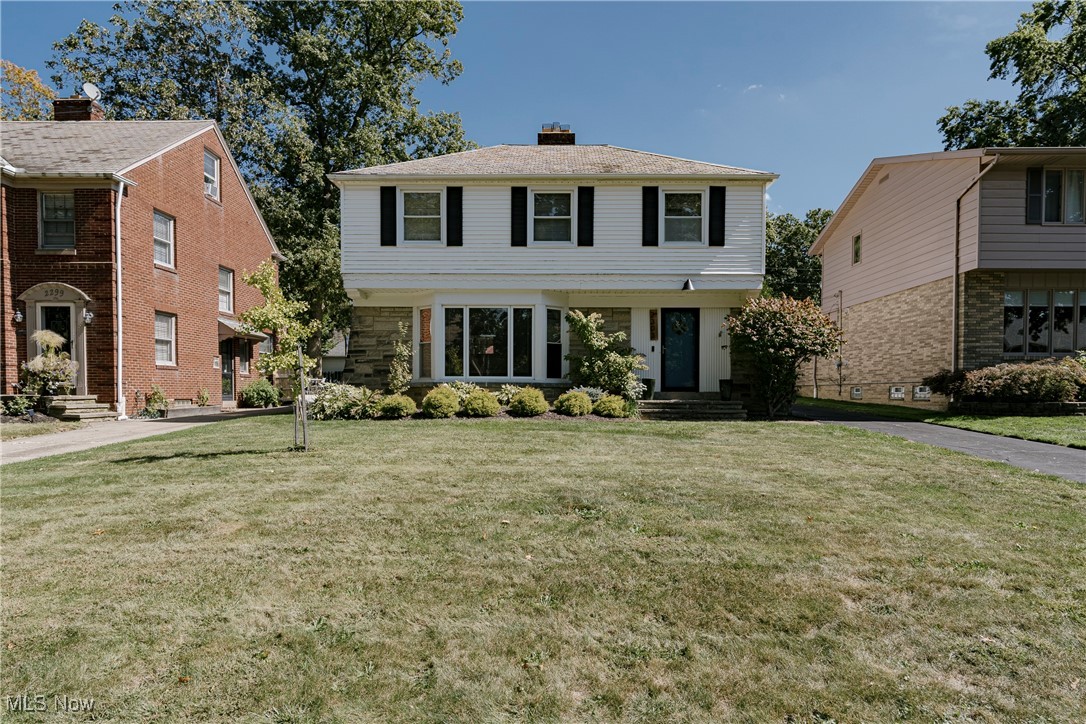 Welcome to 2303 Miramar Blvd.– A Charming Colonial in University Heights! This well-kept, spacious colonial offers 3 bedrooms and 1.5 bathrooms in a highly sought-after neighborhood, blending timeless character with thoughtful updates—perfect for comfortable family living. Step inside to a welcoming foyer that opens into a sun-filled living room, where gleaming hardwood floors, an elegant fireplace, and a classic bay window create the perfect gathering space. The living room flows seamlessly into the formal dining room, also with hardwood flooring, ideal for family dinners and entertaining guests. Just beyond, a bright sunroom provides a cozy retreat with sliding doors leading to the back patio, extending your living space outdoors. The well-appointed kitchen features stone countertops, a subway tile backsplash, stainless steel appliances, and tile flooring. A cheerful breakfast nook offers the perfect spot for casual meals, while a convenient half bath completes the first floor. Upstairs, you’ll find three generously sized bedrooms, each with hardwood flooring, along with a full bathroom that includes both a soaking tub and a step-in shower for everyday ease. The finished lower level adds even more living space with a comfortable recreation room featuring carpeting, warm wood paneling, and a fireplace—perfect for game nights, a home office, or a playroom. The lower level also includes laundry and plenty of storage. Outside, enjoy a private backyard with patio access from the sunroom—perfect for relaxing evenings. Located near shopping, dining, parks, and schools, this home combines convenience, charm, and function, making it a wonderful choice for your next move.